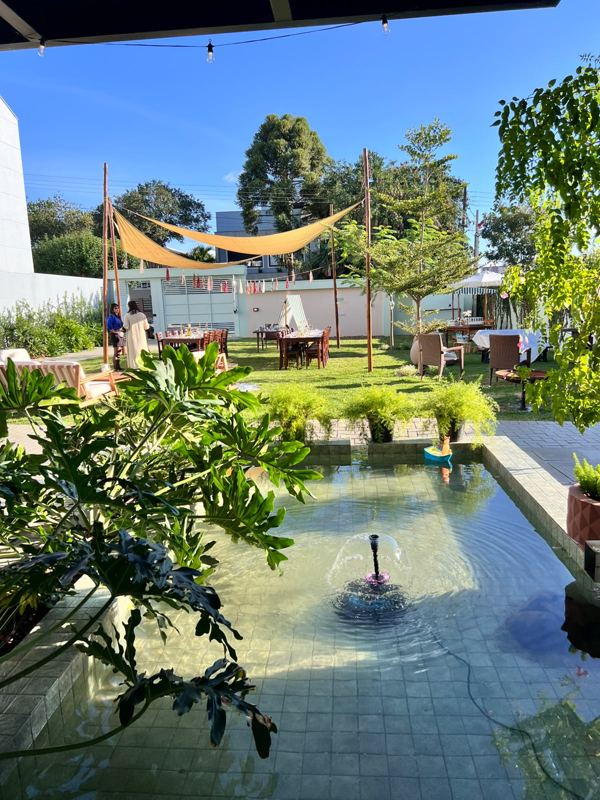 Espelho d'água com fonte no jardim do espaço de festas